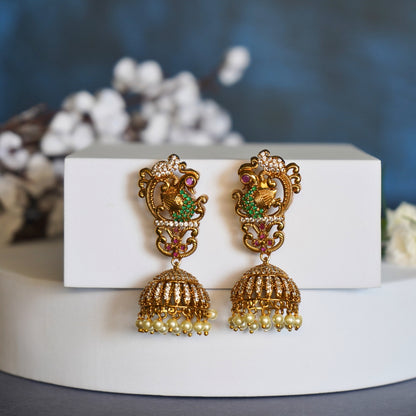 Traditional Gold Jhumka Earrings with Peacock Design and Pearl Accents