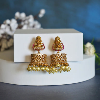 Regal Gold Jhumka Earrings with Mata Lakhsmi and Pearl Accents